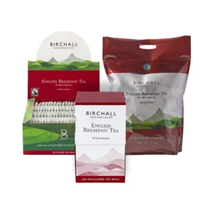 Showcase of Birchall English Breakfast Tea Bags in a café environment, highlighting three distinct packaging options: a box containing 250 enveloped tea bags, a smaller box with 100 tagged tea bags, and a large bag featuring 110 tea bags. Each package is adorned with mountain-themed artwork and bears the Birchall logo, making it an ideal choice for any barista.