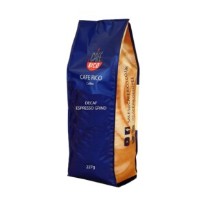 A blue and beige bag of Café Rico Decaf Espresso Grind coffee, weighing 227g, evokes the artistry of a seasoned barista. With social media icons and contact information on the side, it's perfect for those who appreciate a fine brew at home.