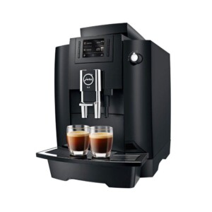 The Jura WE6 Tanked Bean to Cup Coffee Machine is a sophisticated black espresso machine with two spouts that effortlessly dispenses rich coffee into glass cups, ideal for any aspiring barista. Its digital display and intuitive control buttons make it a prized addition to any café setting.